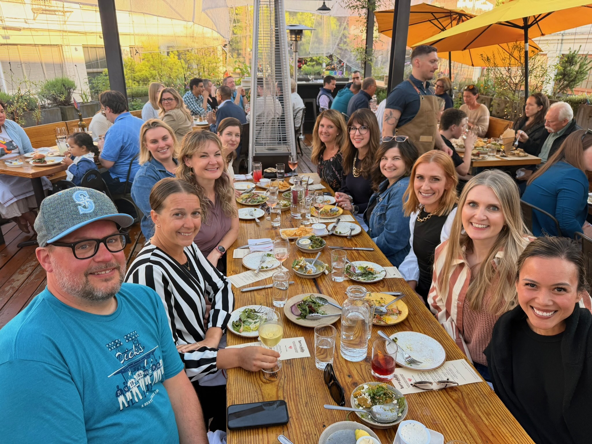 Off the Record members gathered around a patio dinner table in Seattle