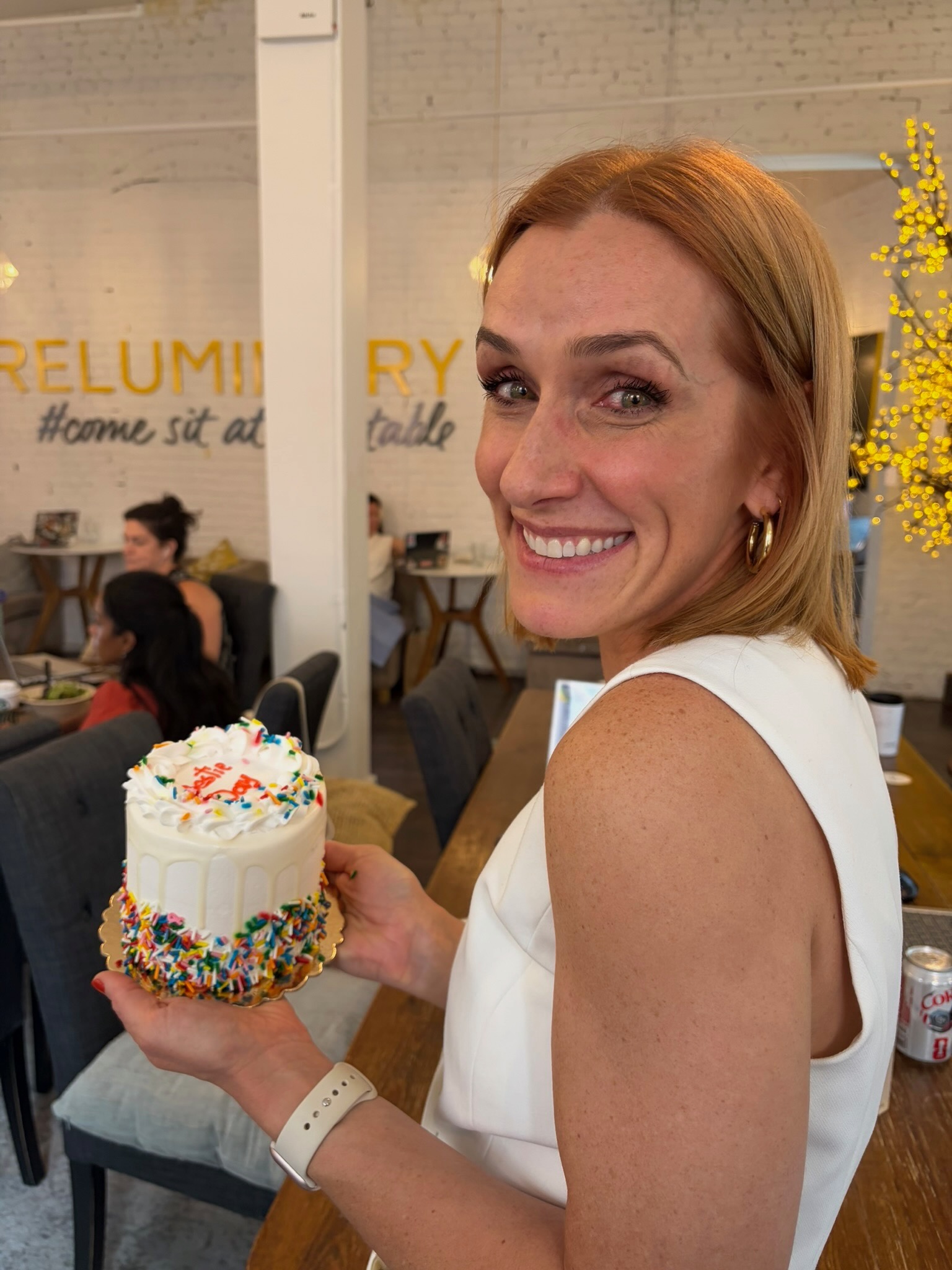 Off the Record members holding a cake at Bestie Day in New York
